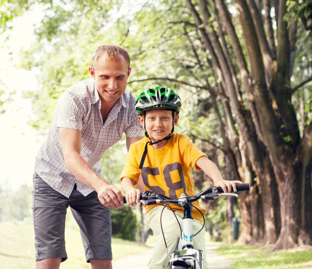 istock Father learn his son to ride bicykle 1284095722