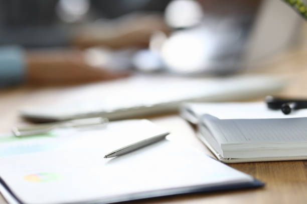 istock On the table is a diary and a report with a pen 1284096664
