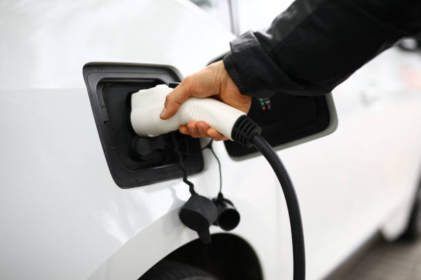 istock The man inserted a fueling hose into the car 1284096735