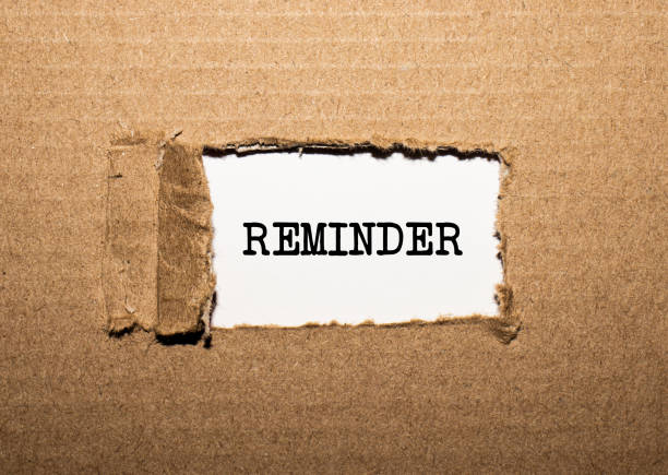 istock The text REMINDER. behind torn brown paper 1284098375