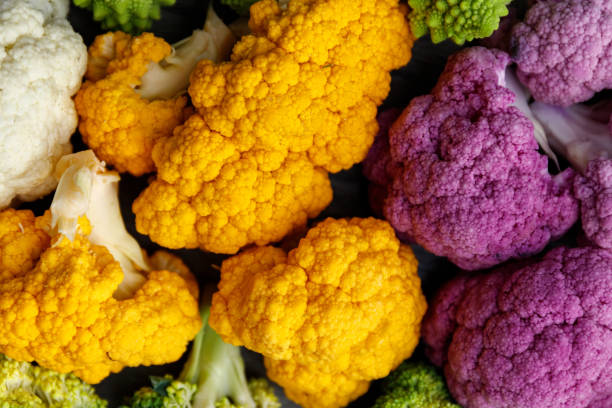 Cauliflower and romanesco broccoli on wooden background. Healthy food concept. Cauliflower and romanesco broccoli on wooden background. Healthy food concept. fractal plant cabbage textured stock pictures, royalty-free photos & images