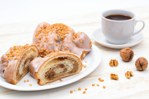 Delicious croissants with coffee Tasty traditional polish croissants  - Croissant of Saint Martin (Rogal witomarciski) with white poppy seeds, nuts and cup of coffee. st. martins stock pictures, royalty-free photos & images
