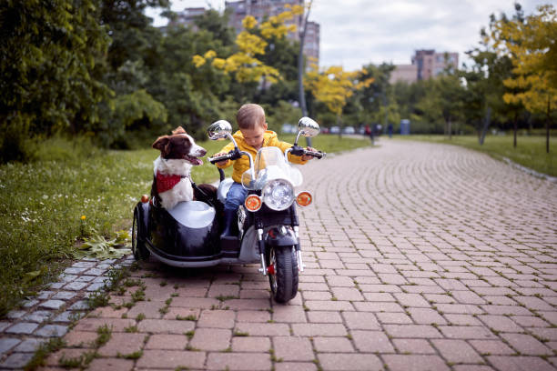 istock Happy little boy driving a toy motorcycle 1284104403