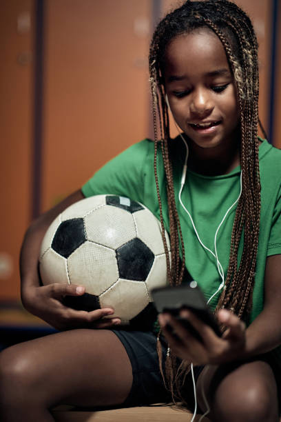 istock Young boy enjoying smartphone content before soccer training. Children team sport 1284108732