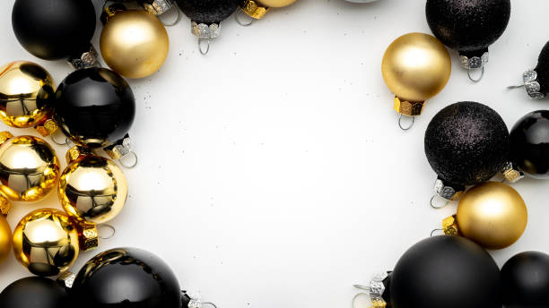 istock Gift boxes background. Gold Christmas baubles decoration on white background with copy space. Xmas backdrop with space for text. 1284110233