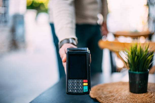 Waiter Holding Pos Device For Contactless Payment Waiter Holding Pos Device For Contactless Payment station stock pictures, royalty-free photos & images