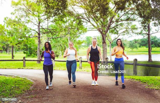 Group Of Women Power Walking Outdoors Stock Photo - Download Image Now - Racewalking, Walking, Exercising