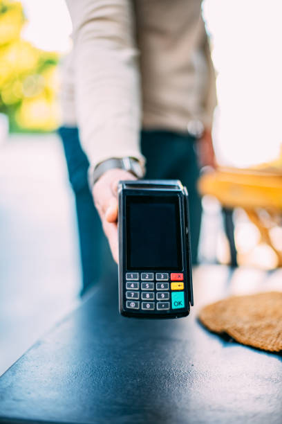 istock Waiter Holding Pos Device For Contactless Payment 1284111770