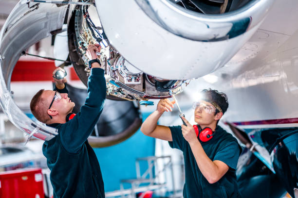 istock Aircraft mechanics working on a jet engine in the airplane hangar 1284111817