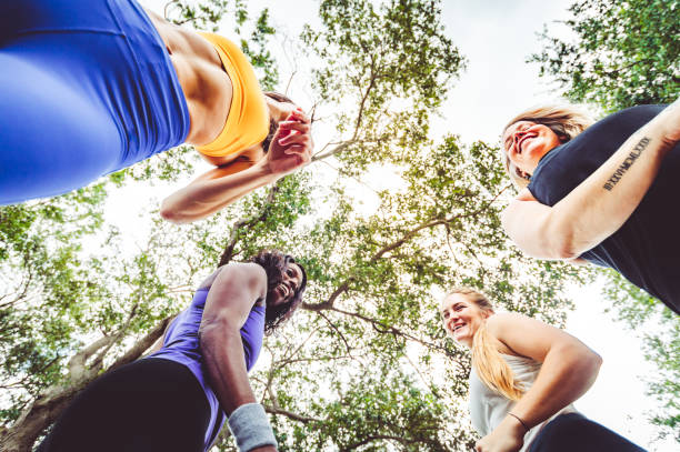 group of female athletes in a candid moment - exercising motivation looking up african descent imagens e fotografias de stock