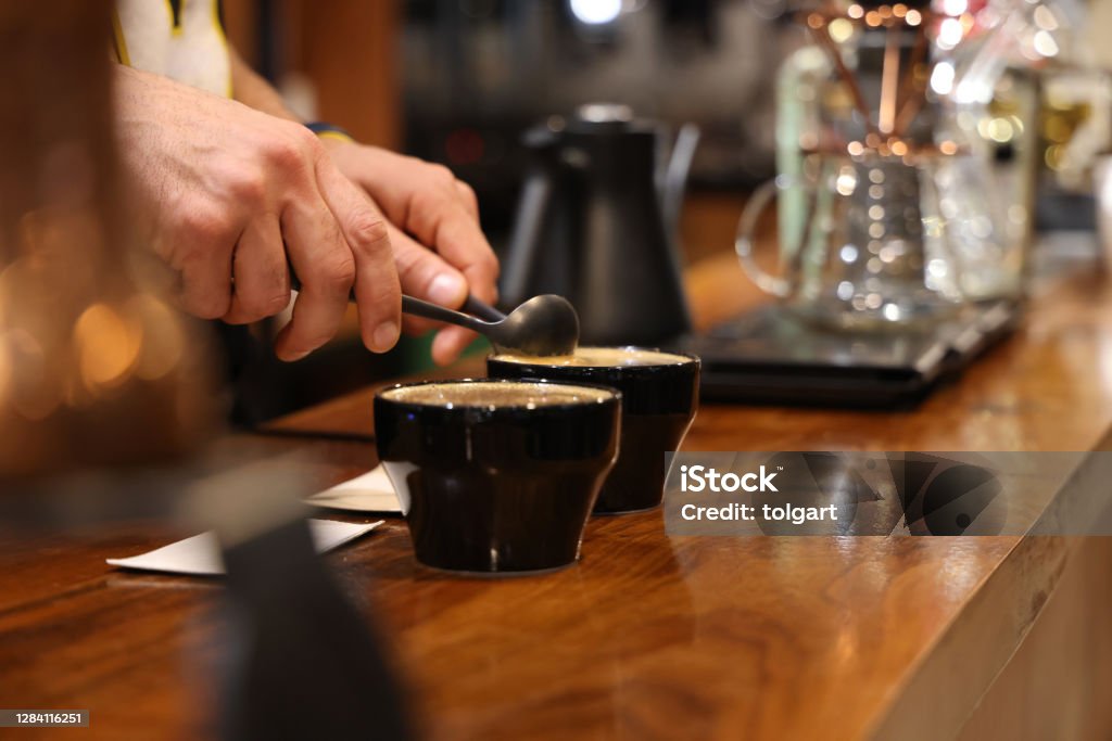 Barista preparing to test and inspecting the quality of coffee Coffee - Drink Stock Photo