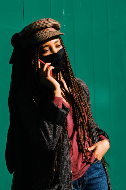 istock black woman with braids making phone call with smartphone 1284116353
