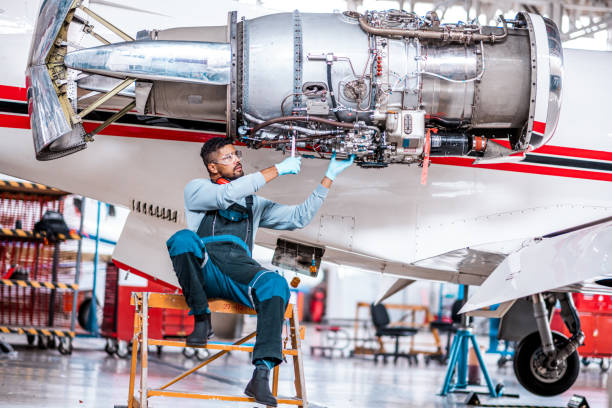 istock Male aircraft engineer works on the jet engine 1284117619