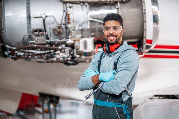 istock Male aircraft engineer stands in front the jet engine 1284117627