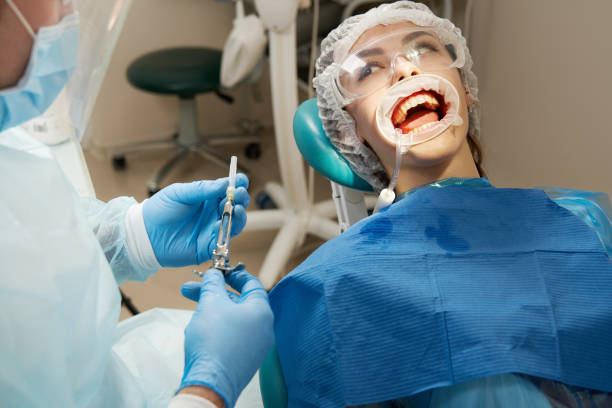 istock Dentist making local anesthesia shot before surgery. Patient visiting a dental office 1284117631
