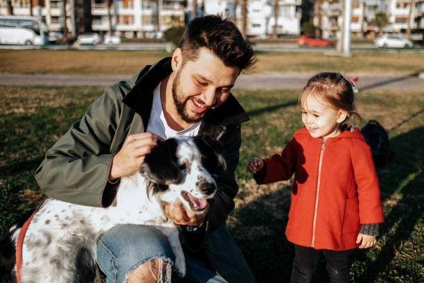 istock Young father and his daughter with a dog 1284117680