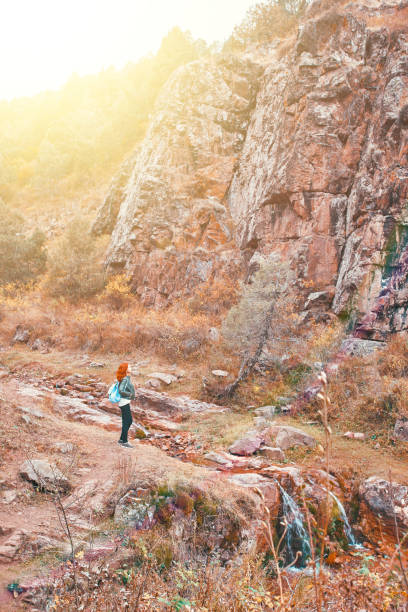 istock Female hiker walking in mountains forest. 1284117752