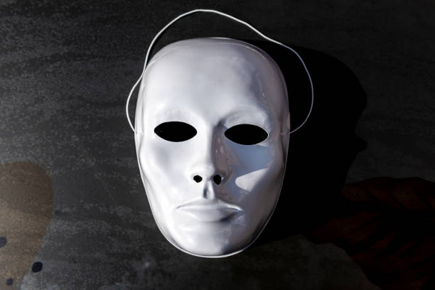 istock White theatrical mask on the black background 1284117780