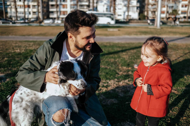 istock Young father and his daughter with a dog 1284118092