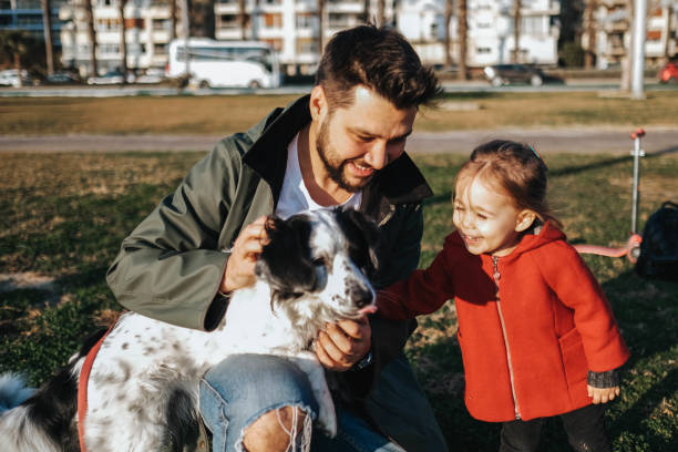 istock Young father and his daughter with a dog 1284118742
