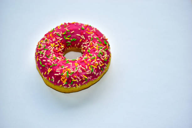 istock Yellow and red American delicious donut on a white background 1284118882