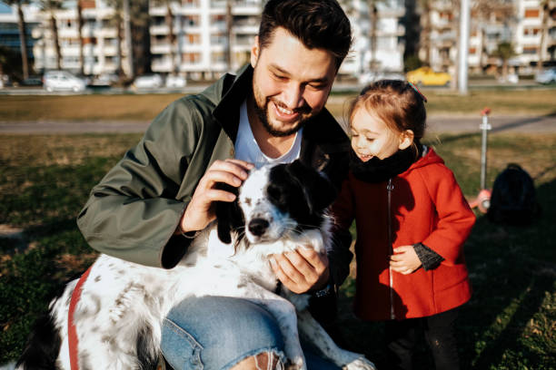istock Young father and his daughter with a dog 1284118908