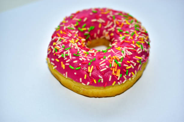 Yellow and red American delicious donut on a white background