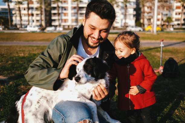 istock Young father and his daughter with a dog 1284119119