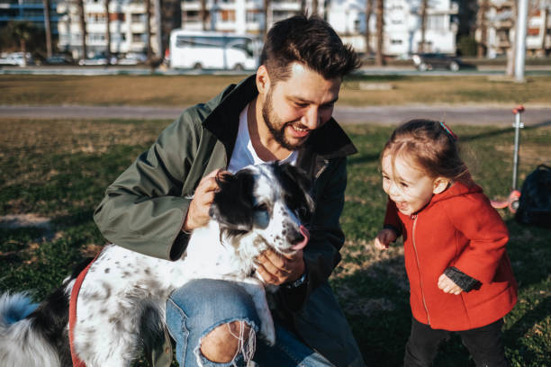 istock Young father and his daughter with a dog 1284119210