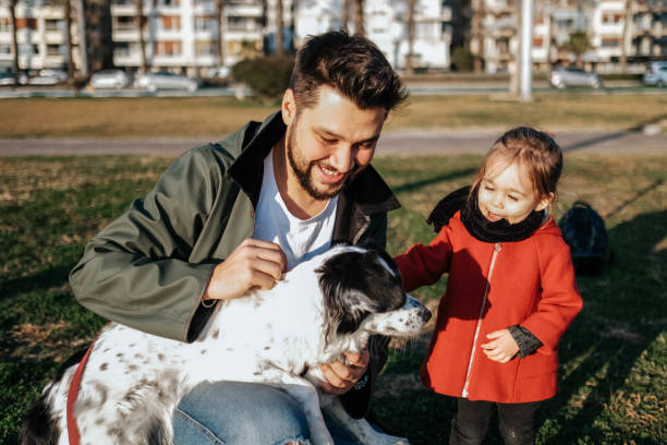 istock Young father and his daughter with a dog 1284119253