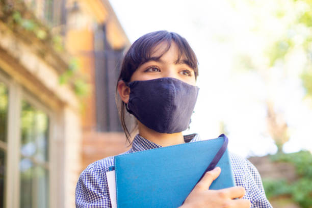 istock student girl with mask 1284120026