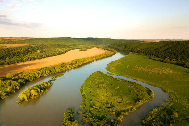 istock Aerial view of bright river flowing through green meadows in spring. 1284120833