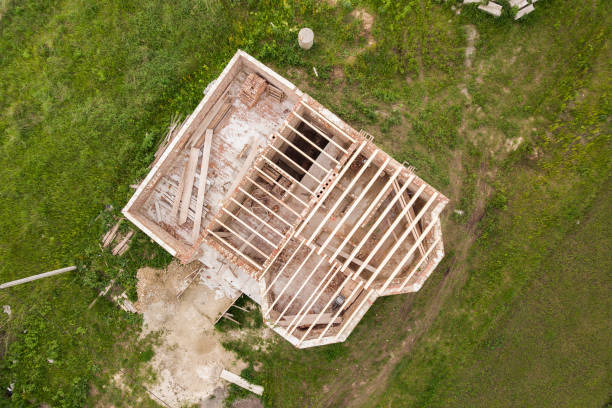 istock Aerial view of a brick house with wooden ceiling frame under construction. 1284120880