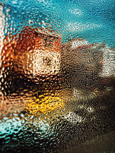 istock Vapor drops on glass with defocused street view. 1284120919
