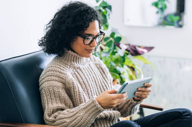 Working from Home: a Young Woman Using a Digital Tablet to Read/Watch Something