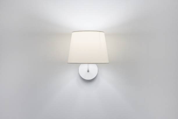 istock White elegant modern wall lamp with textile shade in interior 1284121911