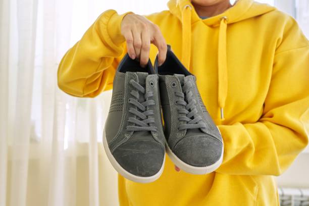istock New men's leather gray sneakers in hands 1284122319