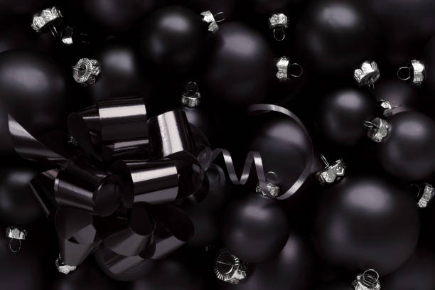 istock Black Friday gift card background, black christmas balls with ribbon bow, template for promotional card with copy space 1284123155
