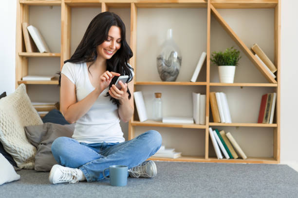 istock Cute happy woman holding cellphone, using mobile dating application to chat or sending romantic message 1284125056