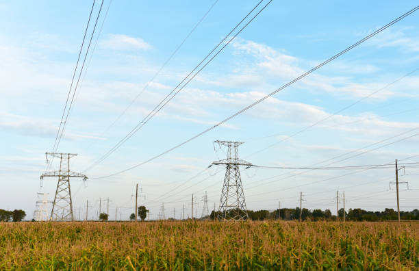 istock High voltage power lines on blue sky background. Electric transmission pylon tower. 1284125261