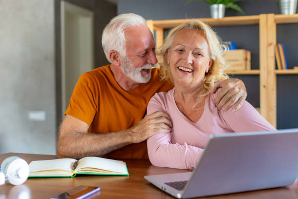 istock Working senior couple at home with laptop 1284126350