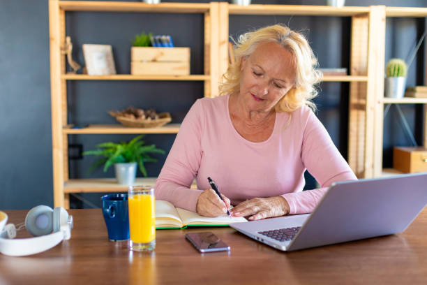 istock Working senior woman at home with laptop 1284126356