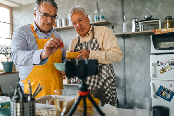 istock Two men recording video blog while cooking food in kitchen 1284128215