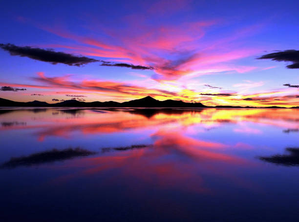 istock Majestic sunset heaven cloudscape reflection in sea tranquil water, awe vibrant colored sky, unique desert landscape, 1284130480