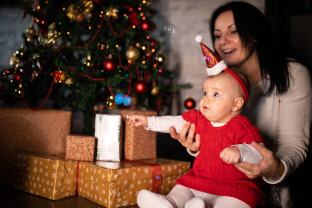 istock Mom and baby celebrating xmas 1284130552