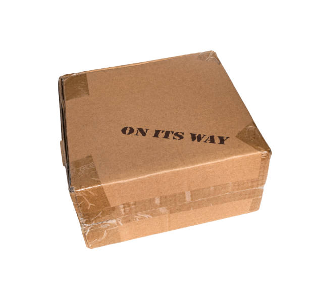istock Cardboard box package wrapped in transparent self adhesive tape conveying the message that the package is on customer's way 1284130593