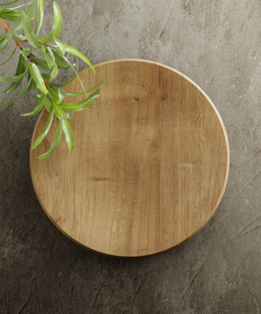 istock Wooden kitchen board. On a grey stone background with leaves. Top view. Free space for text. 3d illustration 1284131265