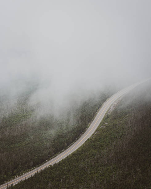 Whiteface Veterans Memorial Highway in fog, in the Adirondack Mountains, New York Whiteface Veterans Memorial Highway in fog, in the Adirondack Mountains, New York whiteface mountain stock pictures, royalty-free photos & images