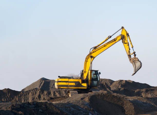 istock Excavator working on earthmoving at open pit mining. Backhoe digs gravel in quarry 1284132505