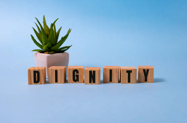 istock Dignity word written on wood block on blue. 1284132721